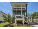 Two-story home with dual porches, light blue siding, and a quaint yard at 632 Warren Ave, Scottdale, GA 30079