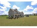 Spacious two-story home features a covered front porch and large front yard at 125 Leveret Rd, Locust Grove, GA 30248
