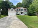 Traditional two-story home with a well-manicured lawn, driveway, and basketball hoop at 2257 Rocksram Ct, Buford, GA 30519