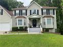 Charming front entrance with covered porch, decorated with plants and seating at 2257 Rocksram Ct, Buford, GA 30519
