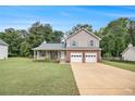 Inviting two-story home with a spacious front lawn and a convenient two-car garage at 4326 Megan Manor Sw Dr, Powder Springs, GA 30127