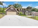 Two-story brick home with a basketball hoop over the driveway and a well-maintained lawn at 5152 Clearwater Dr, Stone Mountain, GA 30087