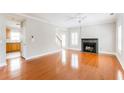 Spacious living room with gleaming hardwood floors, a fireplace, and bright, shuttered windows at 1115 Third St, Stone Mountain, GA 30083