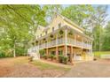 Inviting two-story home with a wide porch, garage, and manicured landscaping, showcasing its curb appeal at 115 Eagle Ridge Dr, Canton, GA 30114