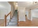 Welcoming foyer featuring a staircase, hardwood floors, and neutral walls, creating an inviting entrance at 115 Eagle Ridge Dr, Canton, GA 30114