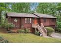 Charming two-story home with an orange door, lush landscaping, and a two car garage at 3679 Regent Nw Dr, Kennesaw, GA 30144