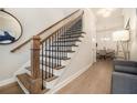 Inviting home entryway featuring a staircase and views into the dining room at 704 Fairlane Dr, Marietta, GA 30064