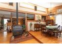 Log cabin dining room with wood burning stove and hardwood floors at 20 Mahan Ne Ln, Rydal, GA 30171