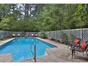 Beautiful fenced in pool with lounge chairs, perfect for relaxing and entertaining at 20 Mahan Ne Ln, Rydal, GA 30171