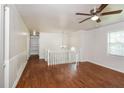 Bright hallway featuring wood floors, white railing, and a classic ceiling fan at 2636 Suzanne Ln, Acworth, GA 30102