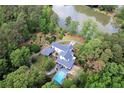 Aerial view of home and property showcasing a swimming pool and lush landscaping at 3109 Country Lake Dr, Powder Springs, GA 30127