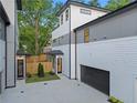 Exterior elevation showcases the side of a modern home with an attached garage and a small, landscaped front yard at 90 Cleveland Unit B Se St, Atlanta, GA 30316