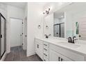 Bathroom featuring double vanity sinks, marble countertops, and a glass-door shower at 2279 Lakeview Pkwy, Villa Rica, GA 30180
