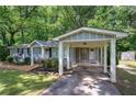 View of a home exterior with carport and lush green lawn at 3710 Lavilla Dr, Powder Springs, GA 30127