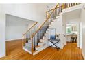 Bright foyer showcases hardwood floors, a staircase with iron railings, and views into the kitchen at 4585 Lakefield Bnd, Berkeley Lake, GA 30096