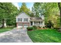 Inviting two-story home with a lovely front porch, two-car garage, and a lush green lawn at 4739 Bradford Ln, Powder Springs, GA 30127