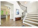 Bright foyer with hardwood floors, staircase, and stylish decor at 242 Fieldbrook Xing, Canton, GA 30115