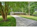 Well-maintained home with a long driveway and mature trees providing ample shade at 2350 Maxine Se Dr, Marietta, GA 30067