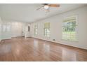 Bright living room featuring gleaming hardwood floors, neutral walls, and multiple windows at 2350 Maxine Se Dr, Marietta, GA 30067