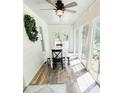 Inviting sunroom with natural light, white table, seating, and views of lush greenery at 3701 Shallowford Rd, Marietta, GA 30062