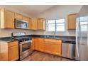 Bright kitchen featuring stainless steel appliances, granite countertops, and wooden cabinets at 5379 Winslow Xing, Lithonia, GA 30038