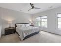 Spacious bedroom with neutral carpet, a ceiling fan, and plenty of natural light from the windows at 963 Forrest St, Roswell, GA 30075