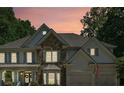 Attractive two-story home featuring stone accents, neutral siding and shutter colors, and a three-car garage at 4050 Arrow Head Trl, Cumming, GA 30041