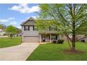 Charming two-story home with gray siding, black shutters, and a well-maintained front yard at 577 Joneus Dr, Mcdonough, GA 30252