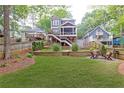 Spacious backyard with tiered landscaping, outdoor seating area, and wooden privacy fence at 79 Anniston Se Ave, Atlanta, GA 30317