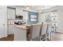 Modern kitchen with stainless steel appliances, a granite countertop island, and white cabinets at 1245 Elowen Dr, Austell, GA 30168