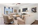 Cozy living room with plush seating, a large TV, and natural light from the windows at 1245 Elowen Dr, Austell, GA 30168
