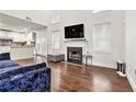 Spacious living room with hardwood floors, fireplace, and open access to the modern kitchen at 2798 Glenlocke Nw Cir, Atlanta, GA 30318