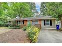 Charming single-story home with brick accents, lovely front yard, and driveway at 3081 Anthony Dr, Decatur, GA 30033