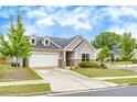 Charming home featuring a two-car garage, stone accents, dormers, and a well-manicured lawn at 463 Marston Pass, Acworth, GA 30102