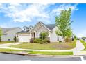 Beautiful house showing the lawn, landscaping and tree with a sidewalk adjacent to the road at 463 Marston Pass, Acworth, GA 30102