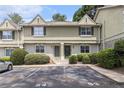 View of a two-story townhome with well-maintained landscaping and marked parking spots at 6900 Roswell Rd # F6, Atlanta, GA 30328