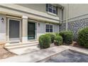 Close-up of the entrance to a two-story townhome with manicured bushes and visible house numbers at 6900 Roswell Rd # F6, Atlanta, GA 30328