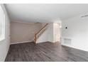 Spacious living room with hardwood floors and staircase offers a bright and airy feel at 6900 Roswell Rd # F6, Atlanta, GA 30328