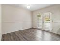 Inviting living space with hardwood floors and french doors leading to outdoor space at 6900 Roswell Rd # F6, Atlanta, GA 30328