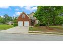 Lovely two-story home featuring brick accents, a lush lawn and mature landscaping at 481 Jefferson Chase Se Cir, Atlanta, GA 30354