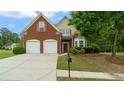 Beautifully landscaped two-story home with a brick front and a two-car garage at 481 Jefferson Chase Se Cir, Atlanta, GA 30354