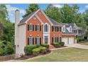 Lovely brick home with two-car garage, manicured lawn and mature trees at 5344 Saint Martins Se Ct, Mableton, GA 30126