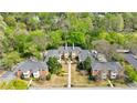 Aerial view of a brick condo building surrounded by mature trees and meticulously maintained landscaping at 115 Peachtree Memorial Nw Dr # C1, Atlanta, GA 30309