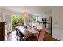 Cozy dining area with a wooden table and chairs, adjacent to a balcony and open to the kitchen at 115 Peachtree Memorial Nw Dr # C1, Atlanta, GA 30309