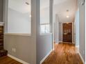 Inviting entryway with wood floors leading to an open living space, enhanced by neutral gray walls at 135 Greenmont Downs Trce, Alpharetta, GA 30009