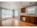 Cozy kitchen with wood cabinets, stainless appliances, and ample natural light from large windows at 135 Greenmont Downs Trce, Alpharetta, GA 30009