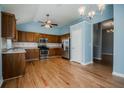 This spacious kitchen features wood cabinets, stainless steel appliances, and stylish hardwood floors at 135 Greenmont Downs Trce, Alpharetta, GA 30009