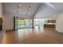 Spacious living room with hardwood floors, fireplace, and folding doors to screened porch at 71 Ramey Rd, Sugar Hill, GA 30518
