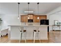 Stylish kitchen featuring modern pendant lighting, stainless steel appliances and a breakfast bar with seating at 10898 Gallier St, Johns Creek, GA 30022