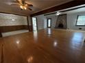 Spacious living room featuring hardwood floors, exposed beams and a fireplace at 237 Sandra Nw Dr, Lilburn, GA 30047